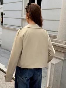 Back view detail of a beige women's casual jacket featuring shoulder epaulettes and yoke