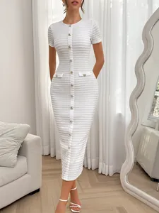 Detail view of a white slim-fit dress with button accents and high-waist design
