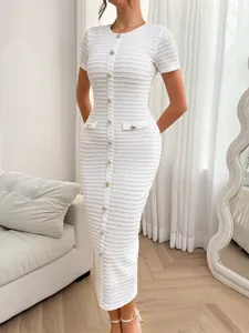 Full-length view of white textured knit slim-fit dress with gold button details