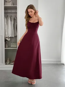 Model wearing a wine red slim-fit cami maxi dress for vacation style