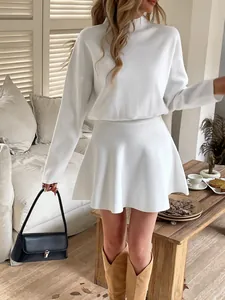 Elegant white long-sleeve knitted two-piece dress set for women in cozy home setting