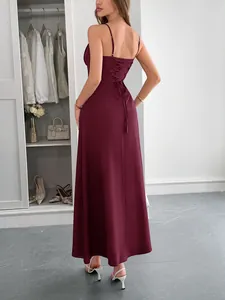 Back view of a burgundy vacation maxi dress featuring an elegant lace-up corset detail.