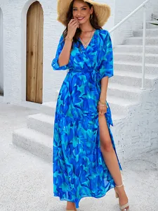 Macro view of elegant blue floral maxi dress with V-neck and stylish high leg slit