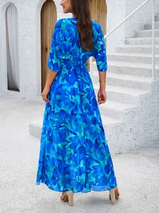 Back view of an elegant blue floral print maxi dress for a summer beach vacation