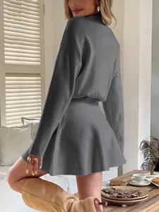 Detailed back view of a gray long sleeve knitted mini dress with a stylish Y2K flared skirt