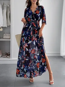 Elegant floral print wrap maxi dress with waist tie and side slit for vacation wear.