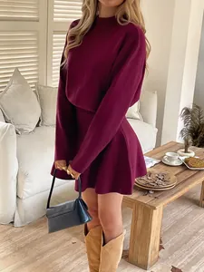 Detailed view of a maroon knit long-sleeve mini dress styled for a stylish autumn look