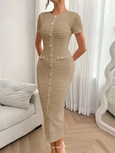 Close-up of a beige short-sleeve slim-fit knit midi dress with decorative silver buttons.