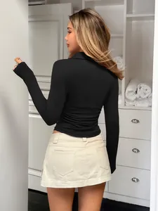 Detailed back view of a slim-fit black long-sleeved shirt featuring elegant feminine curves