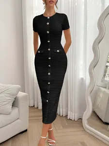 Detail shot of a black button-down bodycon dress on a model in a modern room