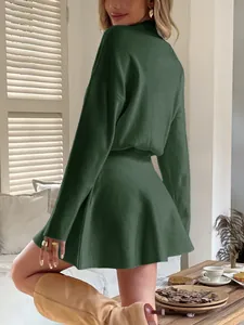 Detailed back view of a dark green Y2K solid color long-sleeved knitted dress in a cozy room
