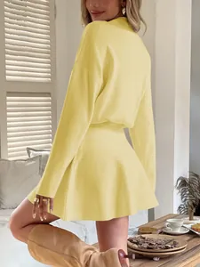 Side back view detail of a chic yellow Y2K style long-sleeved knitted mini dress.