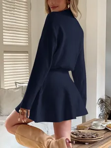 Back view of a Y2K navy blue solid long sleeve knitted mini dress with flared skirt
