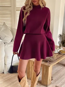 Elegant burgundy long sleeve knit dress with flared skirt and cozy autumn fashion style