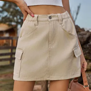 Detail of washed khaki cargo mini skirt featuring elastic waist and utility side pockets.