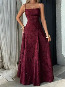 Detailed view of the elegant burgundy floral jacquard pattern on a long maxi dress.