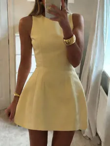 Detailed view of an elegant pale yellow sleeveless mini dress with a structured cinched waist