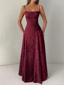Detailed view of the elegant maroon floral jacquard maxi dress with thin spaghetti straps