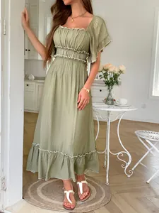 Detail of olive green smocked maxi dress featuring elegant ruffled wood-ear edges