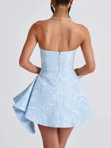 Back view of a French style light blue jacquard tube dress with ruffled hem detail.