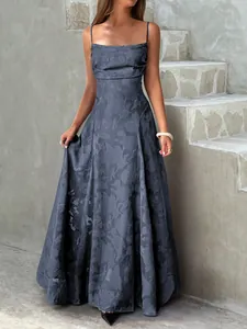 Elegant grey floral jacquard maxi dress with spaghetti straps on concrete background