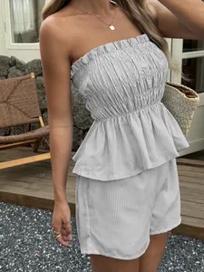 Detailed view of striped strapless peplum top and shorts set with ruffled edges.