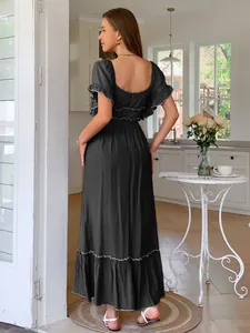 Back view of elegant black maxi dress featuring ruffle sleeves and high-waisted vacation style.