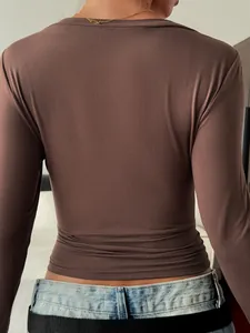 Back view of a slim-fit brown long-sleeved T-shirt for women in casual style