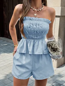 Woman wearing a blue striped tube top and shorts set in a casual summer street style