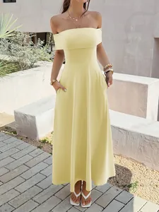 Elegant off-the-shoulder yellow maxi dress with pockets shown in a garden setting