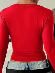 Back view of a slim-fit red long-sleeve top showing smooth fabric and elegant cut