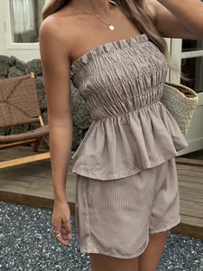 Close-up view of a striped strapless smocked top and matching shorts set for summer