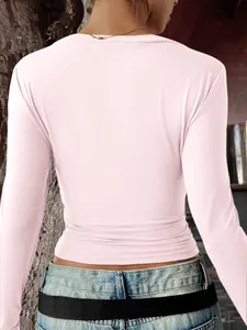 Detailed back view of a slim-fit elegant long-sleeved pink T-shirt for women