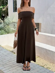 Elegant off-the-shoulder chocolate brown maxi dress showcased in a chic outdoor setting