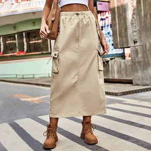 Khaki cargo maxi skirt with drawstring waist and pockets shown on urban street model