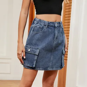 Detail shot of a blue washed denim cargo mini skirt with large functional side pockets
