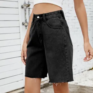 Detail shot of women's black washed denim shorts with stylish frayed hems and a high waist.