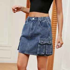 Detail shot of a blue denim cargo miniskirt with elastic waist and large pockets.
