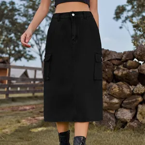 Close-up front view of a black cargo washed denim midi skirt with large utility pockets