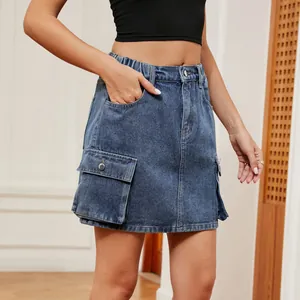 Detail view of blue washed denim cargo skirt with large flap pockets and elastic waist