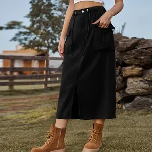 Detail view of black washed denim cargo midi skirt with front slit and drawstring waist.