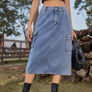 Close-up of a washed denim midi cargo skirt with side pockets in a natural setting