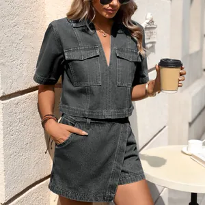 Model wearing a black washed denim two-piece set with V-neck top and irregular skirt