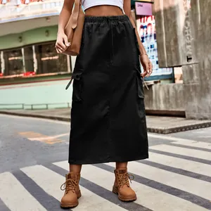Street style detail of a black heavy denim cargo midi skirt with drawstring waist.