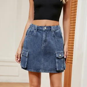 Detail view of denim cargo mini skirt with large flap pockets and elastic waist.
