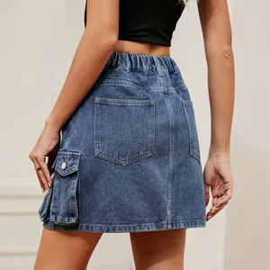 Back view detail of washed blue denim cargo mini skirt with flap pockets and elastic waist.