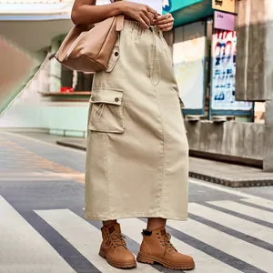 Fashionable outdoor view of khaki denim cargo maxi skirt with drawstring pockets