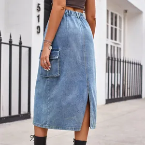 Detailed back view of a light blue denim midi skirt featuring a cargo pocket and slit