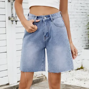Close-up detail of washed straight light blue denim shorts with raw edge hem design