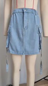 Detailed view of a light blue denim cargo mini skirt with ribbons on a mannequin stand.